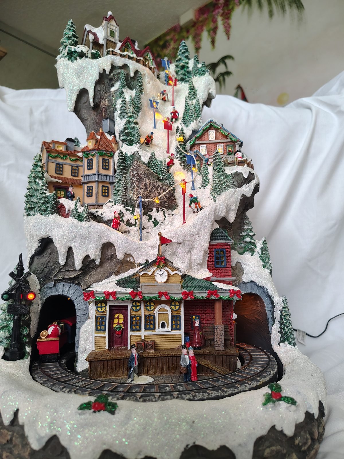 Lighted Christmas mountain village with running train